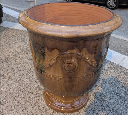 Un vase d'Anduze de couleur flammée posée au sol, dans le centre ancien de Castelnau-le-Lez